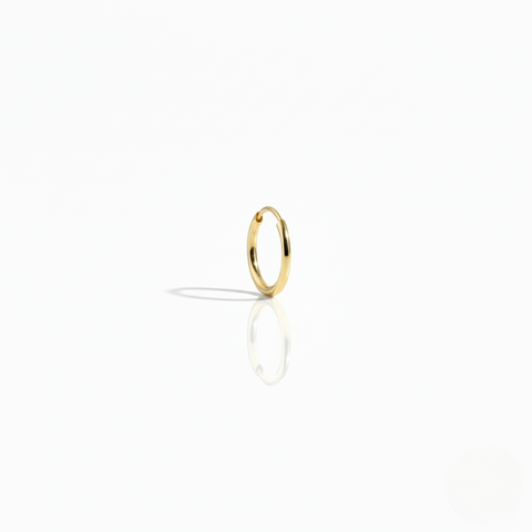 A single polished 10K yellow gold Keeper Hoop earring on a white background, highlighting its seamless, minimal design.