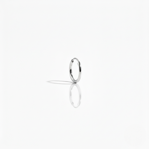 A single polished 10K white gold Keeper Hoop earring on a white background, highlighting its seamless, minimal design.