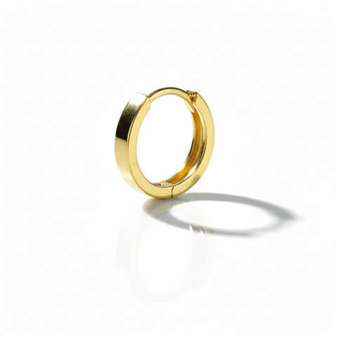 Gold hoop earring on a white background