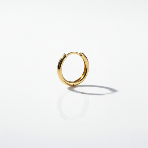 Gold minimal and rounded hoop on a white background