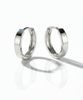 Pair of silver hoop earrings on a white background