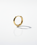 Gold minimal and rounded hoop on a white background